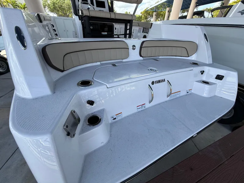 Slide: The Image of 2025 Yamaha Boats 222 FSH Sport E, sleek white deck with cushioned seating. - 4