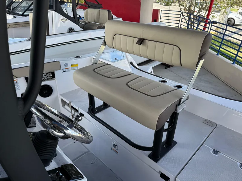 Slide: The Image of 2025 Yamaha Boats 222 FSH Sport E interior with beige seating and steering wheel. - 6