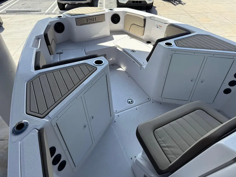 Slide: The Image of 2025 Yamaha Boats 222 FSH Sport E interior with seating and storage compartments. - 9