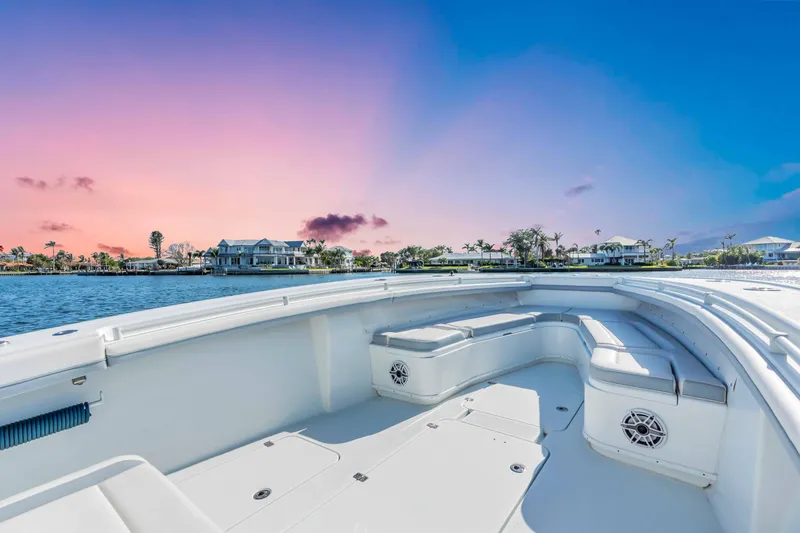 Slide: The Image of 2021 Yellowfin 36 Offshore boat at sunset, featuring spacious deck and waterfront view. - 10
