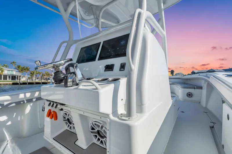 Slide: The Image of 2021 Yellowfin 36 Offshore boat console at sunset, featuring modern controls and speakers. - 11