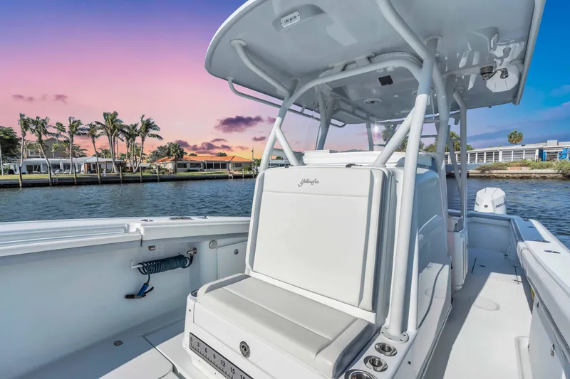 Slide: The Image of 2021 Yellowfin 36 Offshore boat on water at sunset, featuring sleek design and spacious deck. - 13
