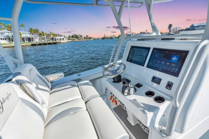Slide: The Image of 2021 Yellowfin 36 Offshore boat interior with modern dashboard and waterfront view. - 14