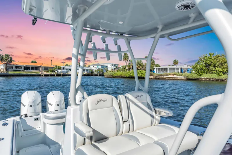 Slide: The Image of 2021 Yellowfin 36 Offshore boat on water at sunset, featuring luxurious seating and dual engines. - 15
