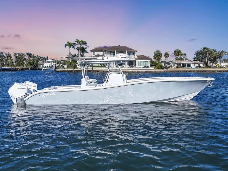 Slide: The Image of 2021 Yellowfin 36 Offshore boat on water, with coastal homes in the background. - 3