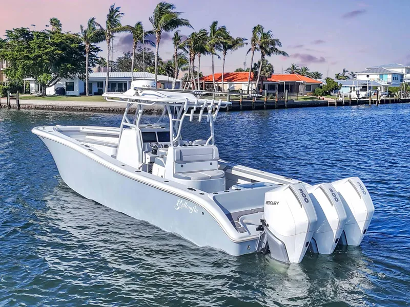 Slide: The Image of 2021 Yellowfin 36 Offshore boat with triple engines on a calm waterfront. - 5