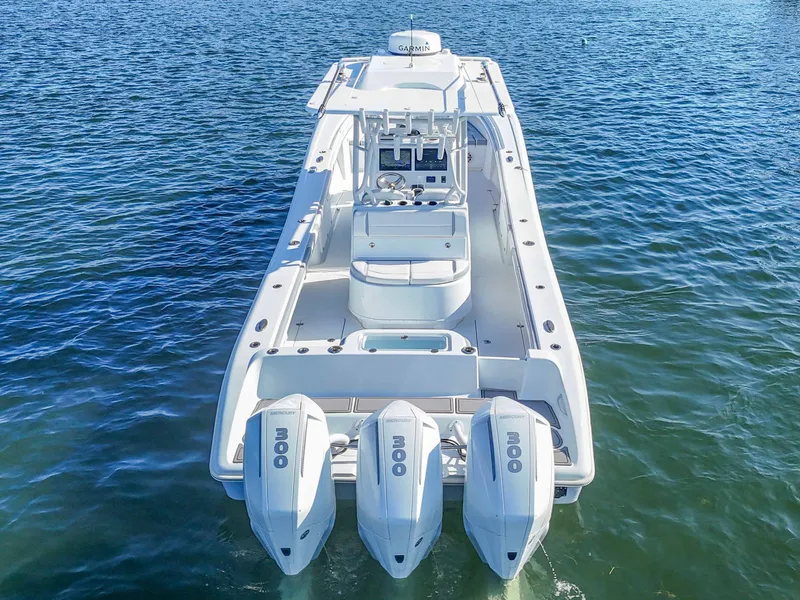Slide: The Image of 2021 Yellowfin 36 Offshore boat with triple outboard engines on open water. - 7