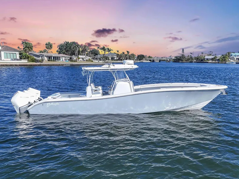 Slide: The Image of 2021 Yellowfin 36 Offshore boat on calm water at sunset. - 8