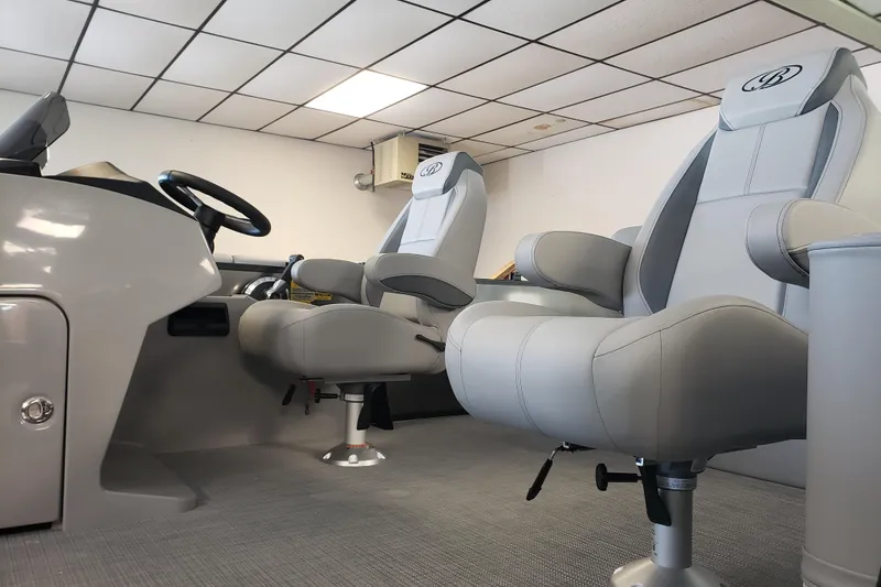 Slide: The Image of 2025 Bentley Pontoons Legacy Swingback interior with modern seating and steering console. - 2