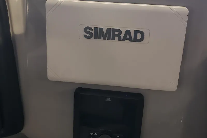 Slide: The Image of Simrad navigation system on 2025 Bentley Pontoons Legacy Swingback boat dashboard. - 5