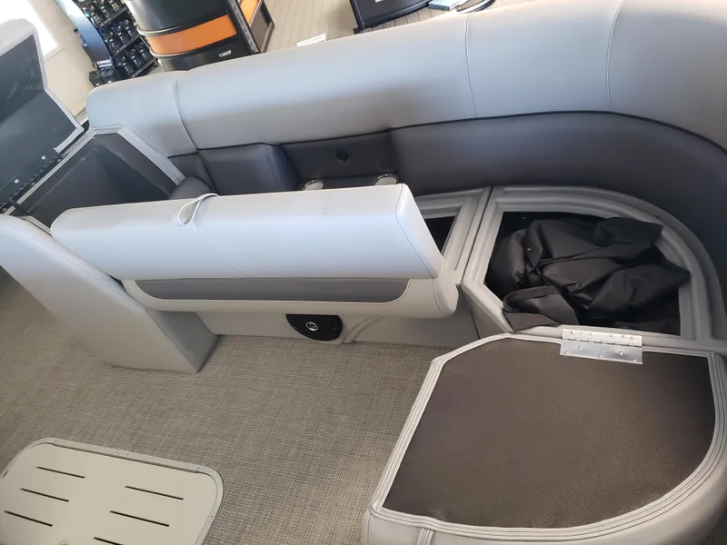 Slide: The Image of 2025 Bentley Pontoons Legacy Swingback interior seating with storage compartments. - 9