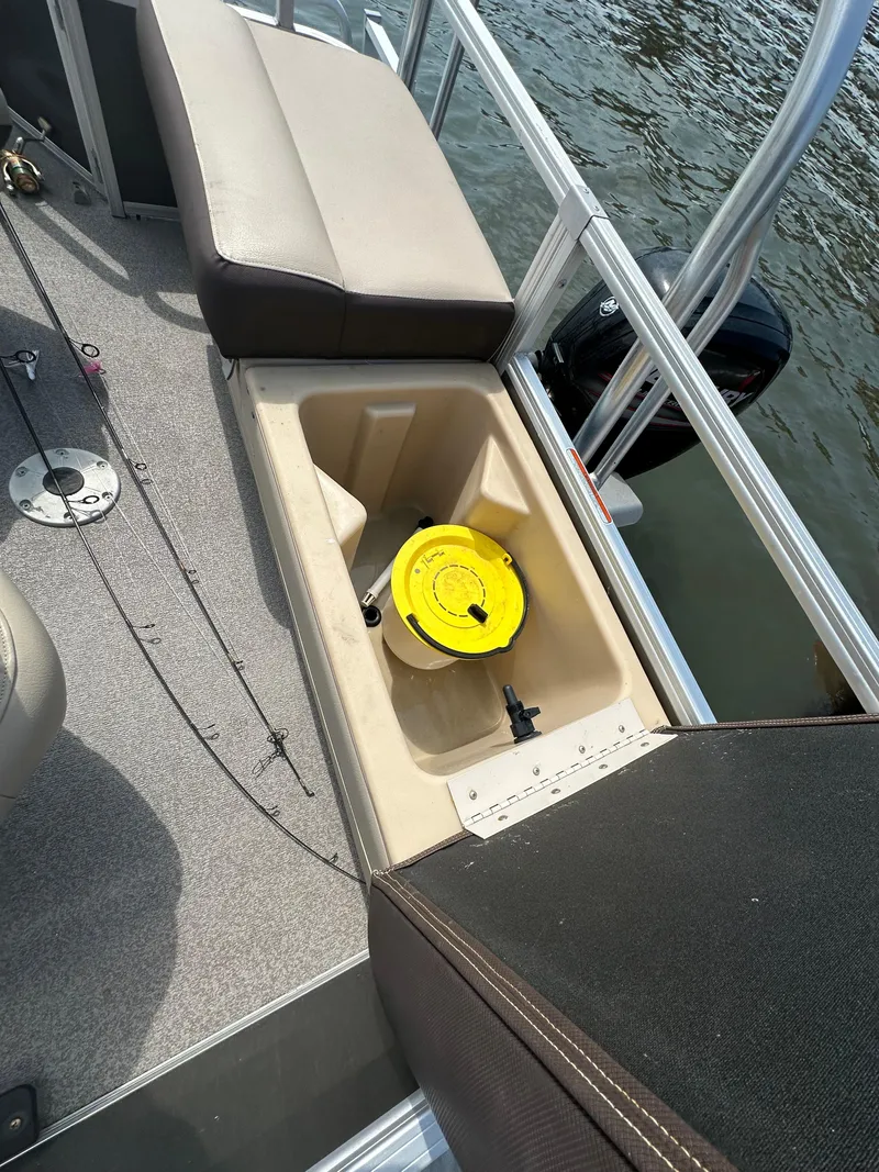 Slide: The Image of 2018 Sun Tracker Fishing Barge 22 with open storage compartment and yellow container. - 11
