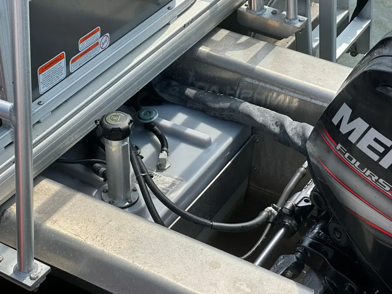 Slide: The Image of 2018 Sun Tracker Fishing Barge 22 engine compartment with Mercury FourStroke motor. - 12
