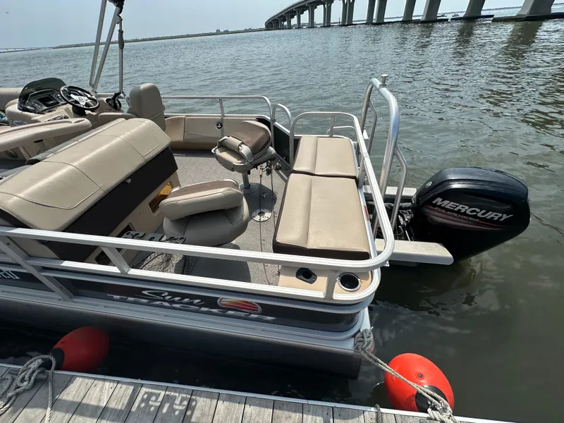 Slide: The Image of 2018 Sun Tracker Fishing Barge 22 pontoon boat docked with Mercury outboard motor. - 14