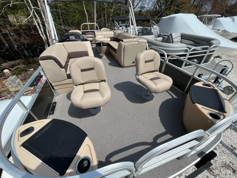 Slide: The Image of 2018 Sun Tracker Fishing Barge 22 with beige seating and spacious deck layout. - 2