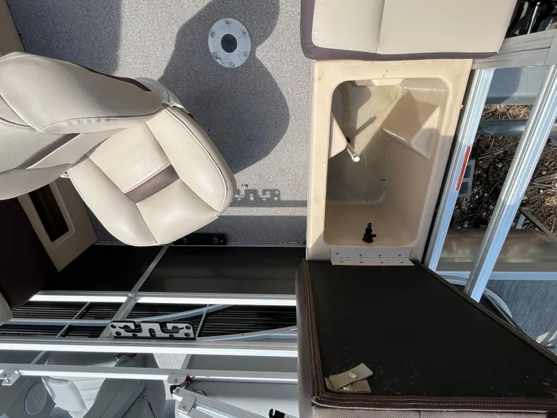 Slide: The Image of 2018 Sun Tracker Fishing Barge 22 interior with seating and storage compartments. - 21