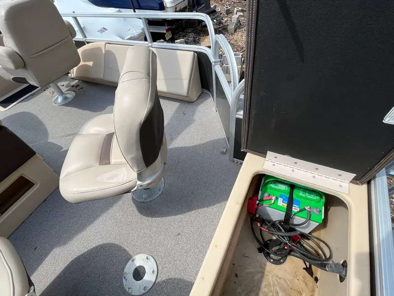 Slide: The Image of 2018 Sun Tracker Fishing Barge 22 interior with seating and battery compartment. - 22