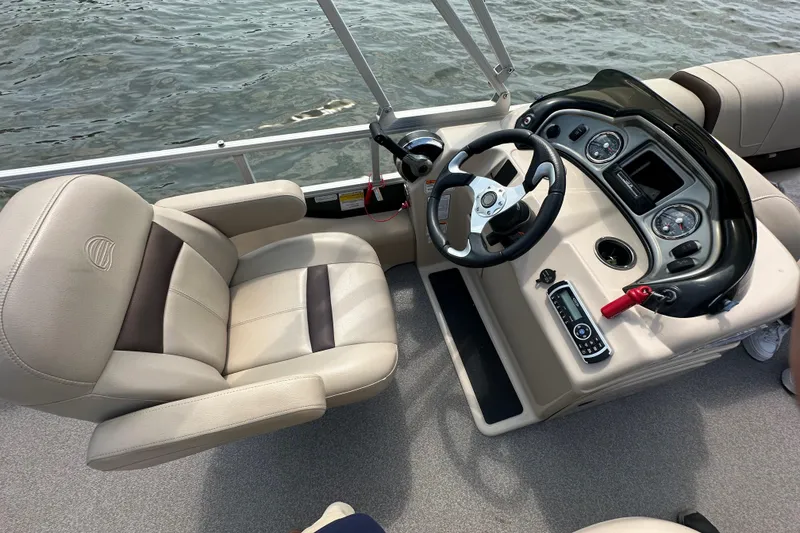 Slide: The Image of 2018 Sun Tracker Fishing Barge 22 interior with steering console and comfortable seating. - 25