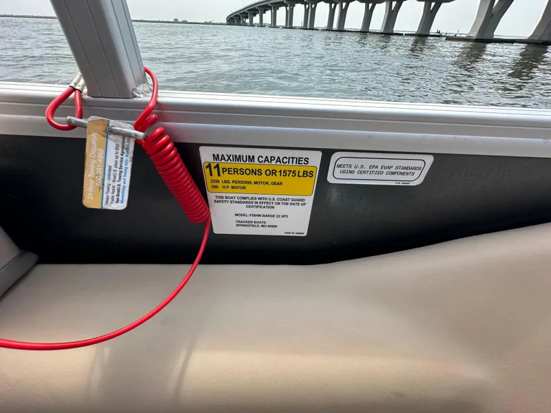 Slide: The Image of 2018 Sun Tracker Fishing Barge 22 interior with capacity label, red safety cord, and bridge view. - 5