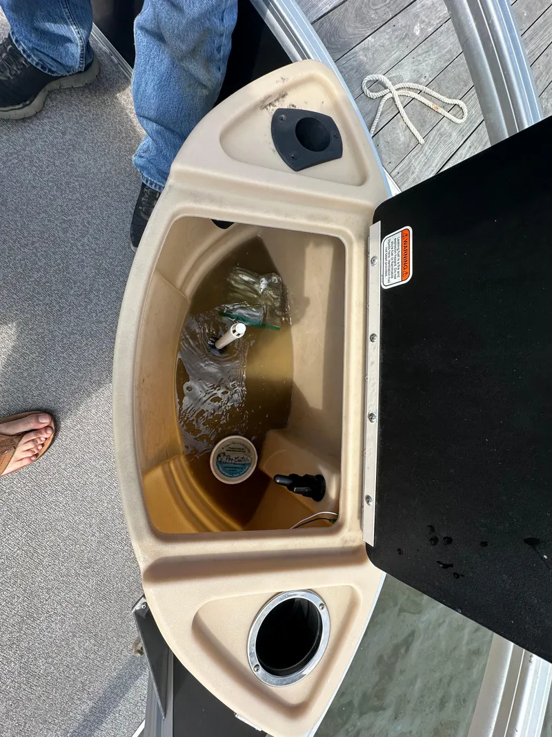 Slide: The Image of 2018 Sun Tracker Fishing Barge 22 storage compartment with fishing gear and accessories. - 7