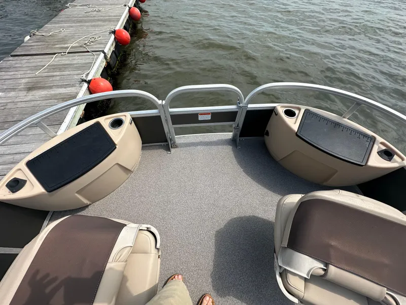 Slide: The Image of 2018 Sun Tracker Fishing Barge 22 at dock, featuring spacious seating and storage. - 9
