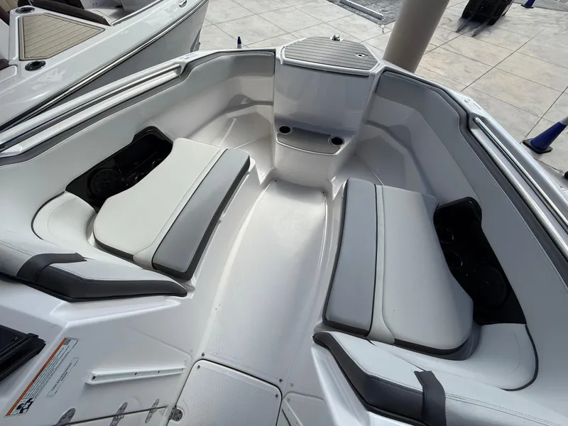 Slide: The Image of 2025 Yamaha Boats AR250 interior with white seating and modern design. - 9