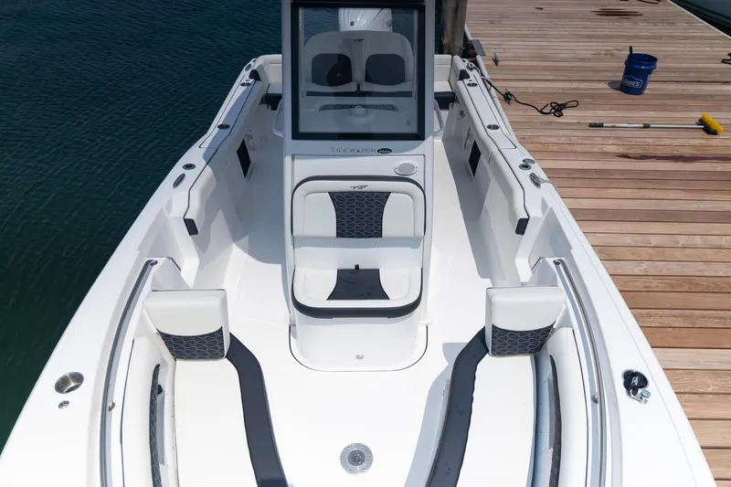 Slide: The Image of 2025 Tidewater 230 LXF boat docked, showcasing sleek seating and modern design. - 14