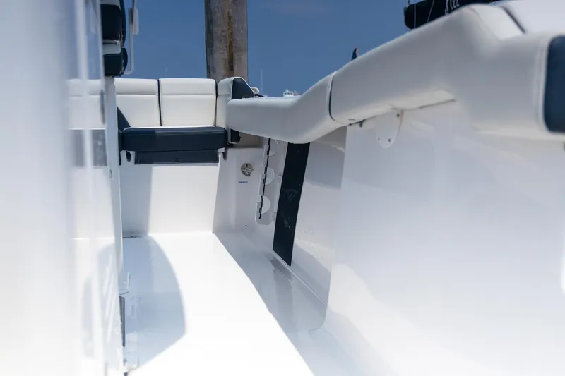 Slide: The Image of 2025 Tidewater 230 LXF boat interior with sleek white seating and modern design. - 15