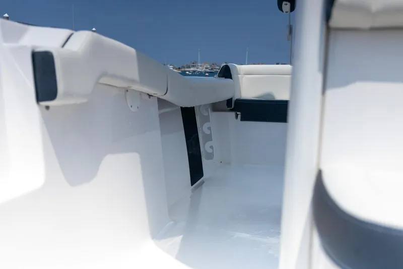 Slide: The Image of 2025 Tidewater 230 LXF boat interior, showcasing sleek white seating and modern design. - 16