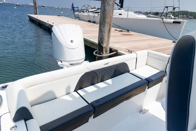 Slide: The Image of 2025 Tidewater 230 LXF boat docked, featuring sleek seating and powerful outboard motor. - 18
