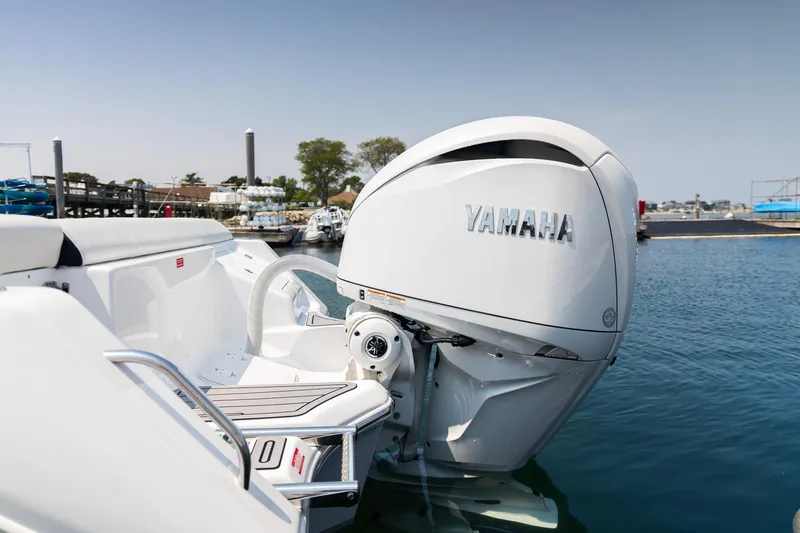 Slide: The Image of 2025 Tidewater 230 LXF boat with Yamaha outboard engine, docked in a marina. - 20