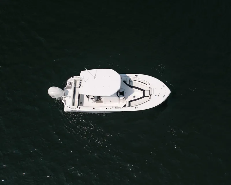 Slide: The Image of Aerial view of 2025 Tidewater 230 LXF boat on dark water. - 29