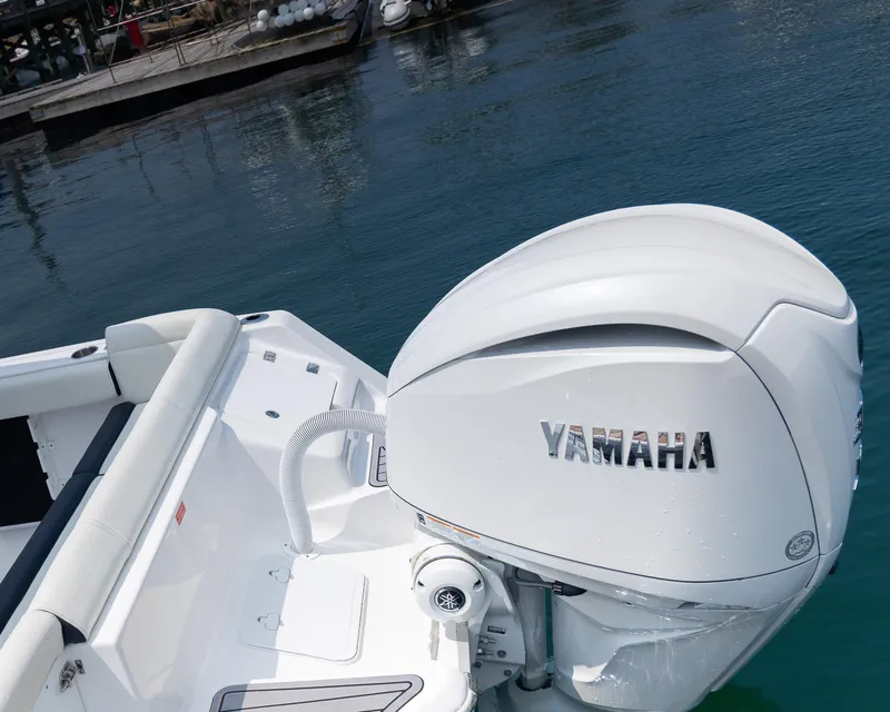 Slide: The Image of 2025 Tidewater 230 LXF boat with Yamaha outboard engine on calm water. - 7