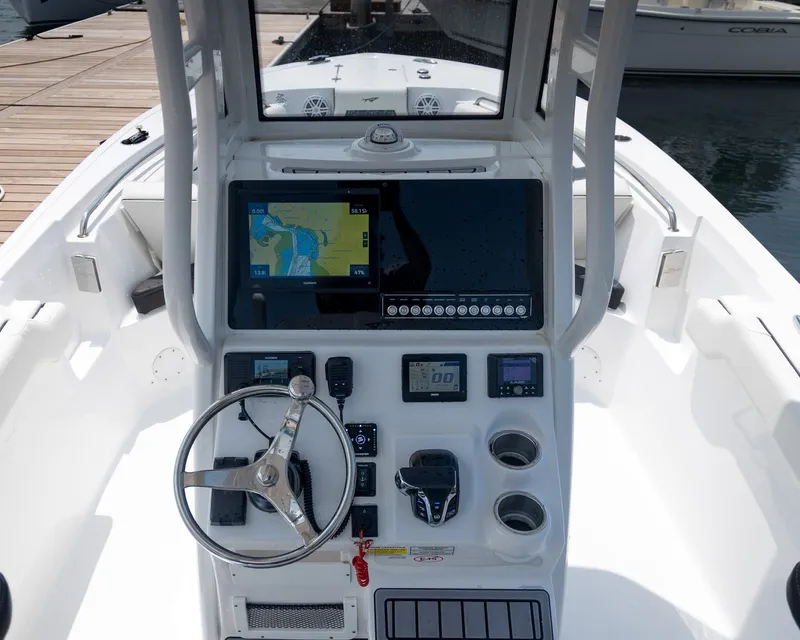Slide: The Image of 2025 Tidewater 230 LXF boat console with navigation display and steering wheel. - 9