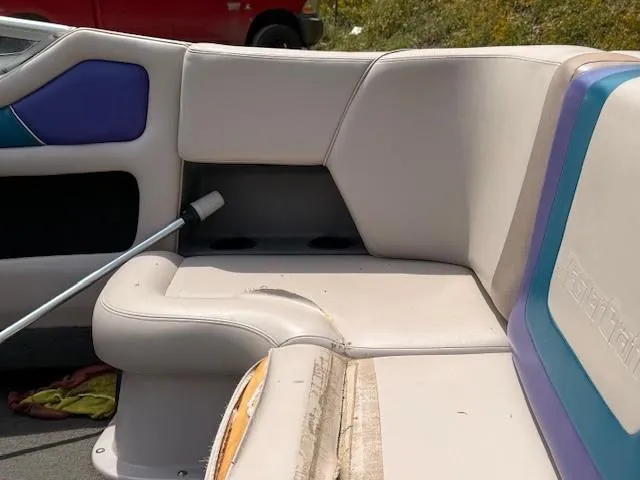 Slide: The Image of 1995 MasterCraft MARISTAR 225 VRS LT1 boat interior with worn upholstery and cleaning brush. - 14