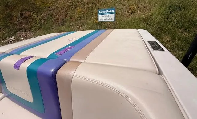 Slide: The Image of 1995 MasterCraft MARISTAR 225 VRS LT1 boat with colorful upholstery near reserved parking sign. - 15