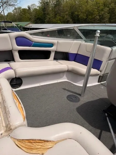 Slide: The Image of 1995 MasterCraft MARISTAR 225 VRS LT1 boat interior with cushioned seating and carpeted floor. - 19