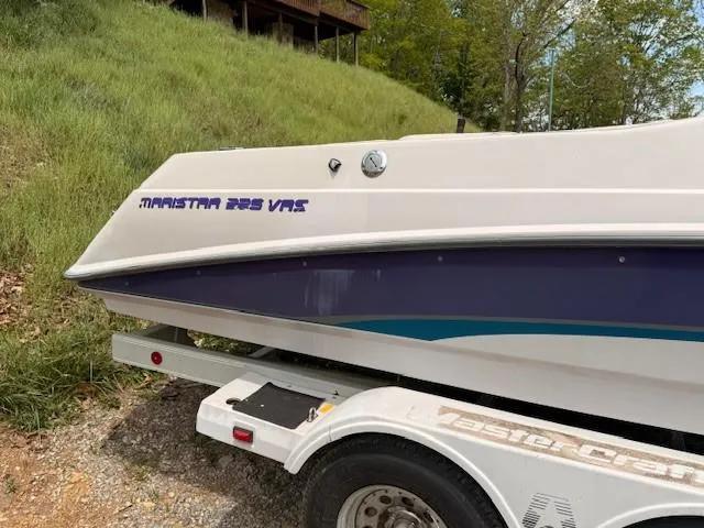 Slide: The Image of 1995 MasterCraft MARISTAR 225 VRS LT1 boat on trailer, parked on grassy area. - 5