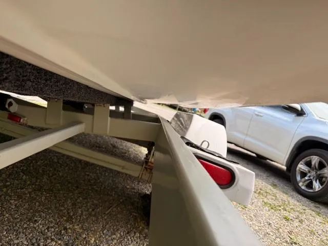 Slide: The Image of 1995 MasterCraft MARISTAR 225 VRS LT1 boat trailer, close-up view, parked beside a car. - 8