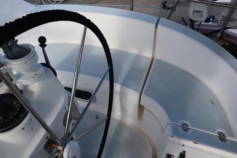 Slide: The Image of Cockpit of a 1997 Hunter 37 sailboat with steering wheel and navigation instruments. - 11