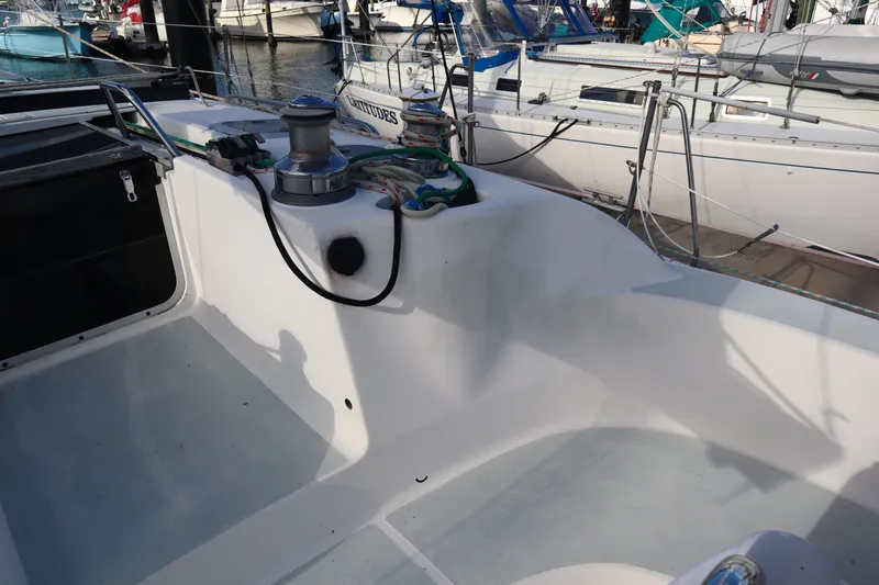 Slide: The Image of Cockpit of a 1997 Hunter 37 sailboat, featuring winches and mooring lines. - 13