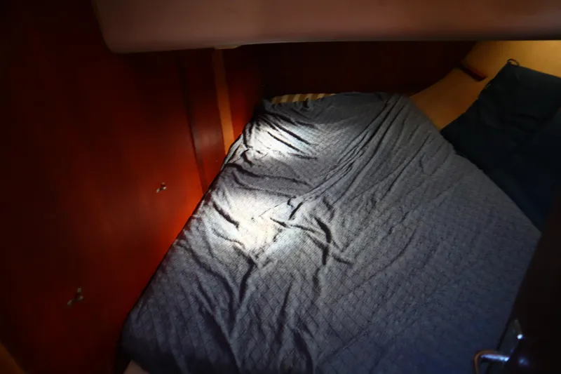 Slide: The Image of Cozy cabin interior of 1997 Hunter 37 sailboat with blue bedding. - 23