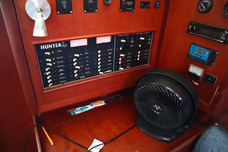Slide: The Image of Control panel of a 1997 Hunter 37 sailboat with fan and wooden interior. - 26