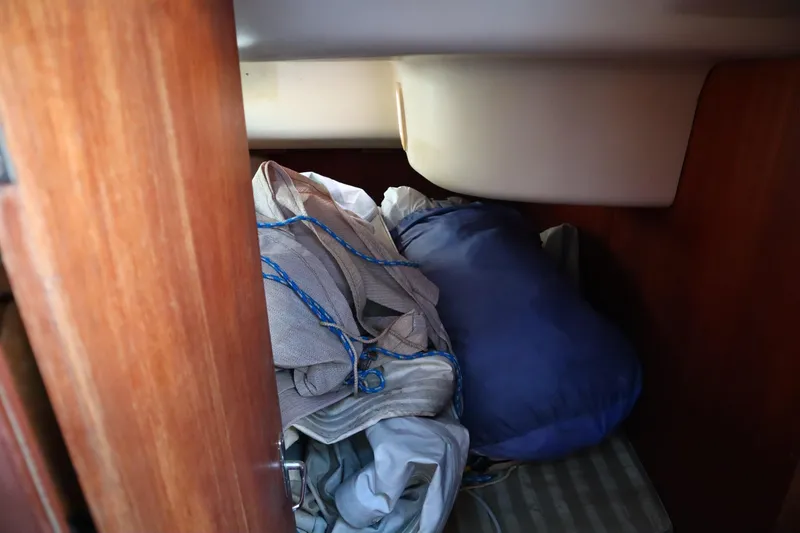 Slide: The Image of Interior cabin storage of 1997 Hunter 37 sailboat with ropes and fabric. - 28
