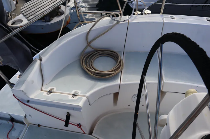 Slide: The Image of 1997 Hunter 37 sailboat cockpit with coiled rope and steering wheel. - 8