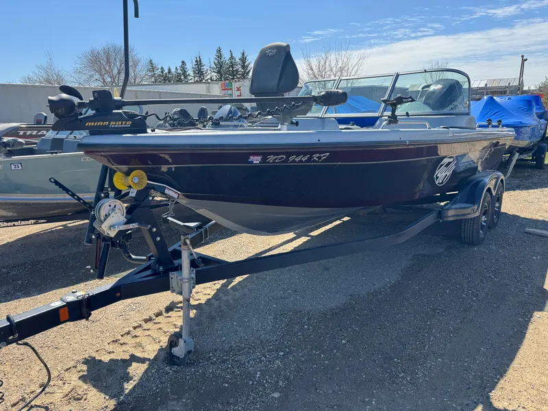 Slide: The Image of 2016 Tuffy Osprey 2100 boat on trailer, parked outdoors under clear sky. - 1