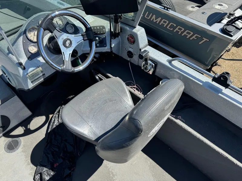 Slide: The Image of Interior of a 2016 Tuffy Osprey 2100 boat with steering wheel and seat. - 10