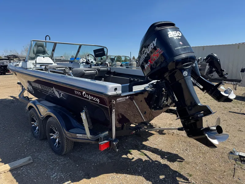 Slide: The Image of 2016 Tuffy Osprey 2100 boat with Mercury 350 Pro XS engine, parked outdoors. - 4