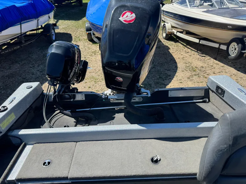 Slide: The Image of Tuffy Osprey 2100 boat, 2016 model, with outboard motor, parked among other boats. - 8