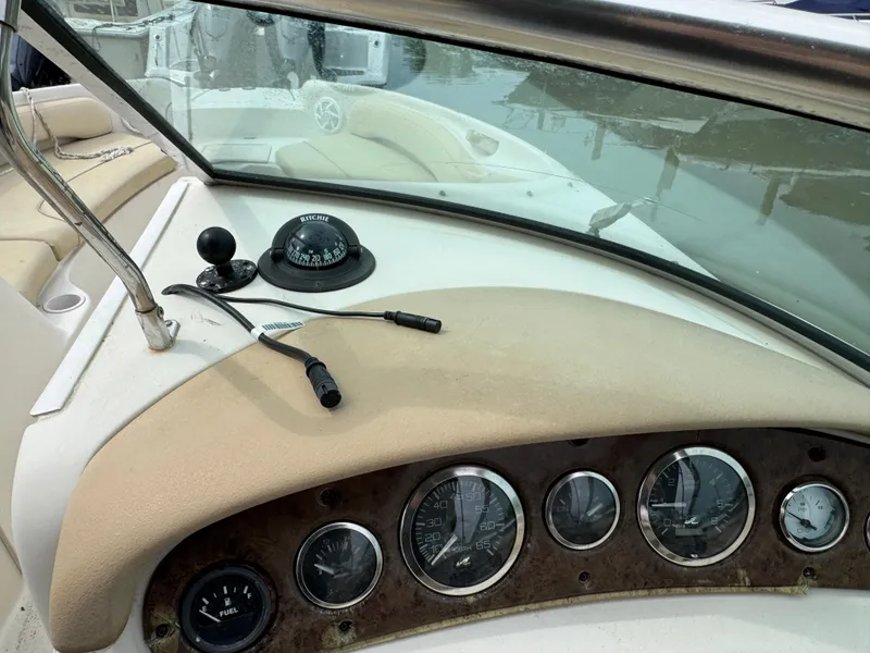 Slide: The Image of Dashboard of 2001 Sea Ray 240 Sundeck boat with gauges and compass. - 10